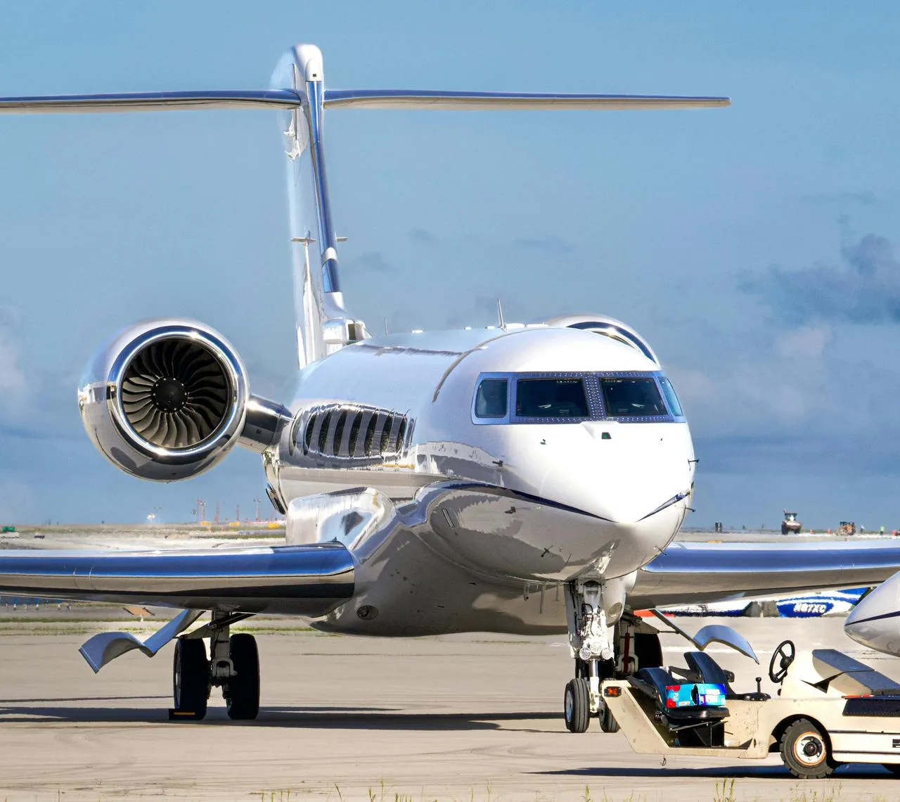 Front view of an executive private jet being prepared on the tarmac during ground handling operations